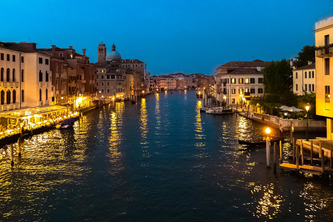 Stunning view of Venice's Grand Canal illuminated at night, capturing the historic architecture and vibrant atmosphere.