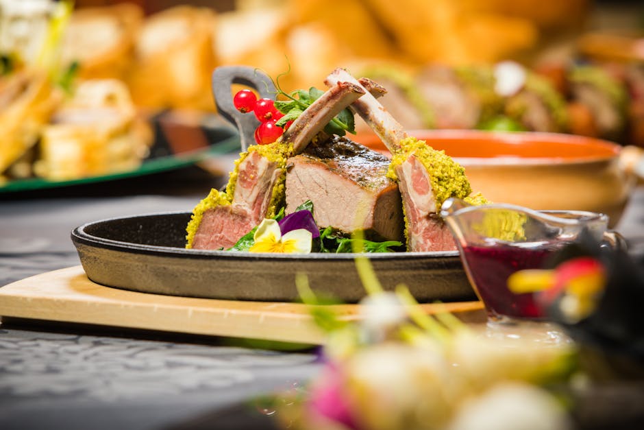 Delicious lamb chops with herb crust served with vibrant garnish and sauce.